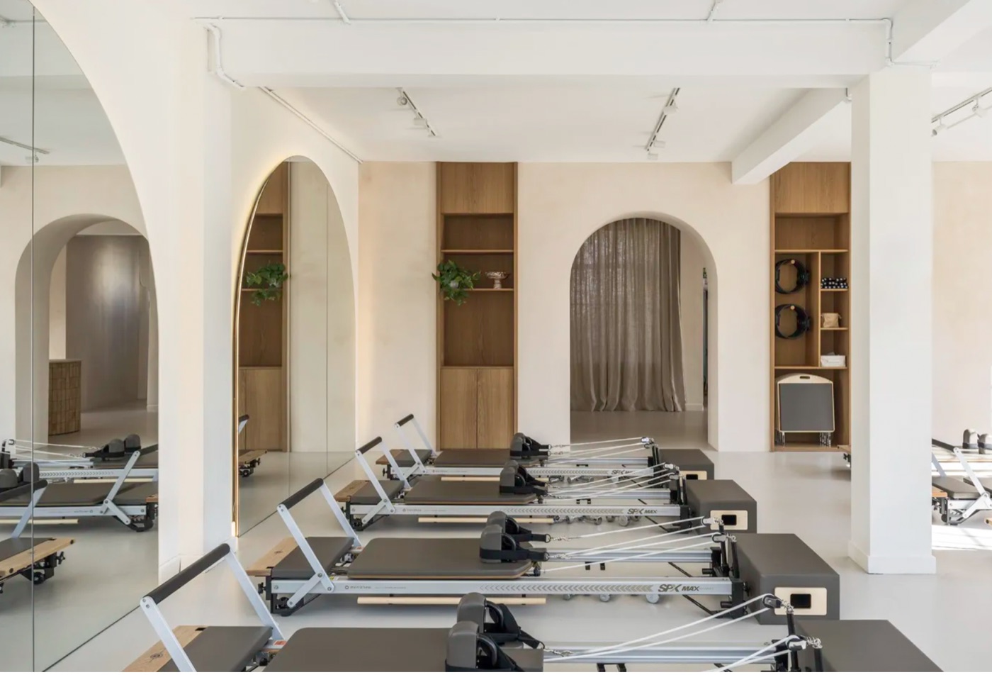 A bright Pilates studio with rows of reformers